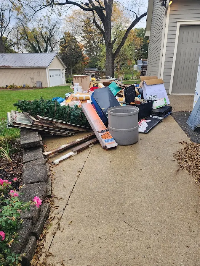 Dumpster being loaded with debris for Roofing Dumpster Rental in Valparaiso